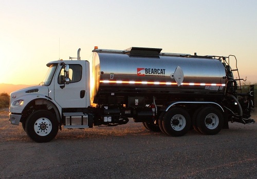 An asphalt distributor in the sunset, part of BearCat's Chip Seal Equipment for Sale